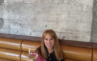 Photo of Hilary Reiter Azzaretti with a glass of wine